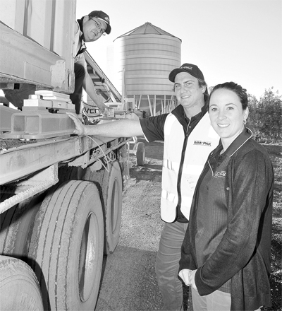 Wimpak's Todd Krahe and Sarah Spicer (right) show off their efficent container scales with plant operator Brock Tait (left).